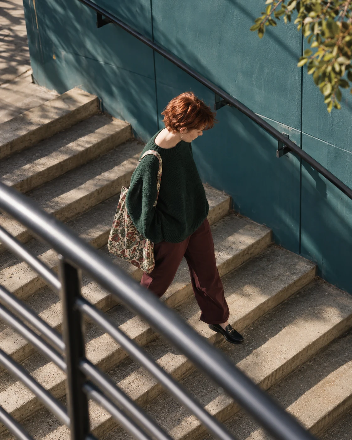 A young woman descending outdoor stairs, photographed from above